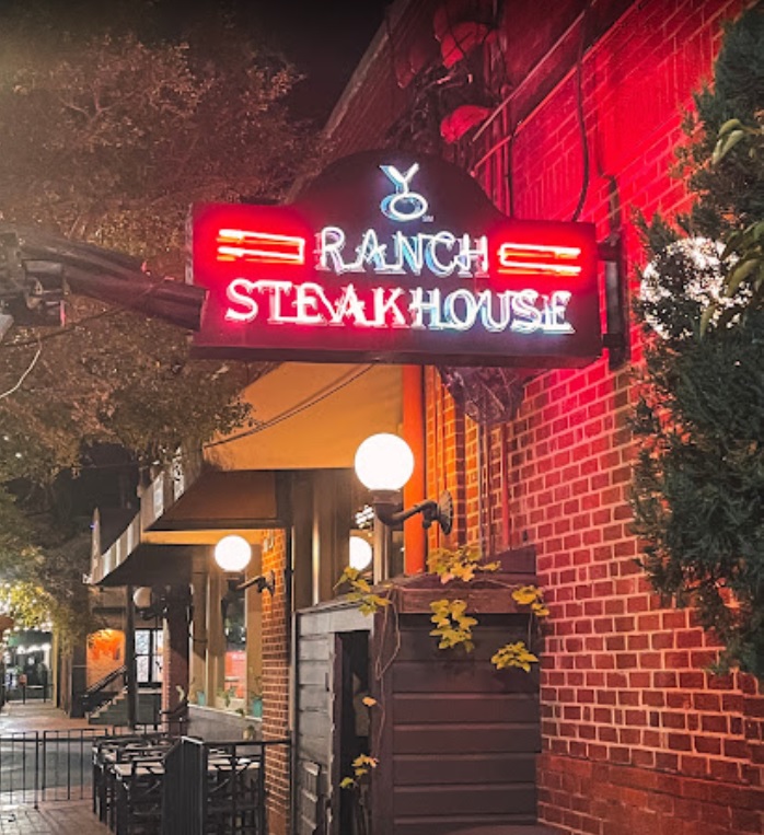 YO Ranch Steakhouse lit sign from the street view